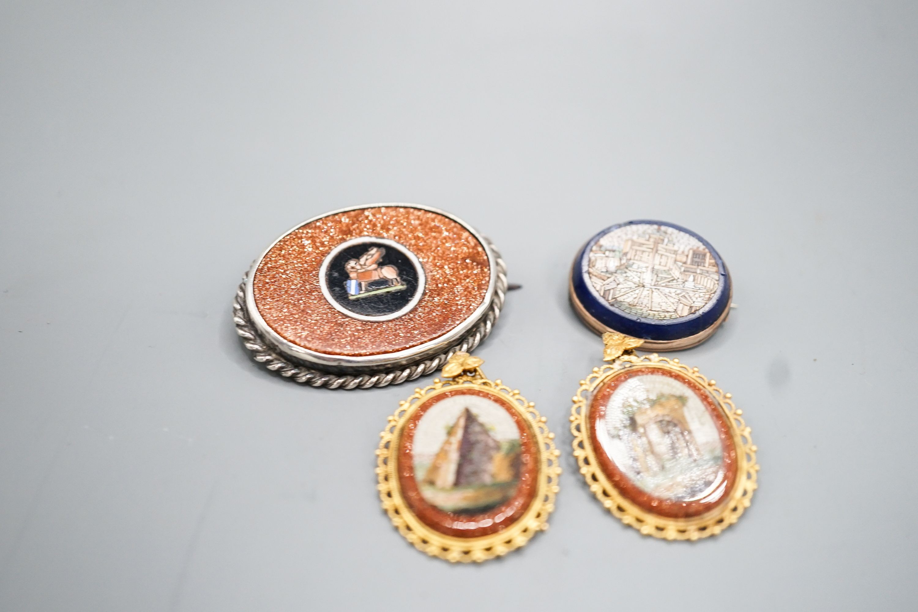 A pair of yellow metal mounted adventurine glass and micro mosaic oval earrings, decorated with ancient architecture, 32mm, a small micro mosaic oval brooch and a white metal mounted adventurine glass and micro mosaic ov